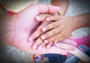 Hand of an elderly holding hand of younger